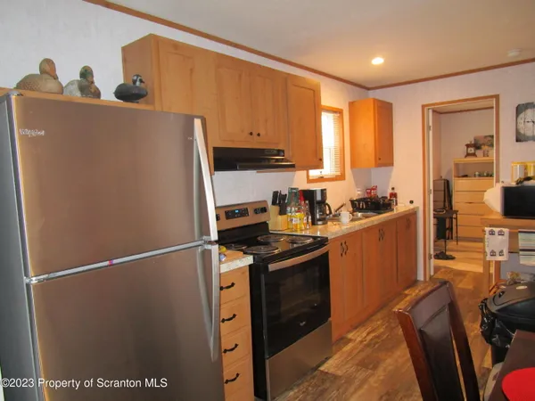 a kitchen with stainless steel appliances granite countertop a refrigerator sink and cabinets
