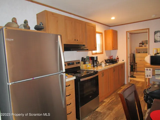 a kitchen with stainless steel appliances granite countertop a refrigerator sink and cabinets