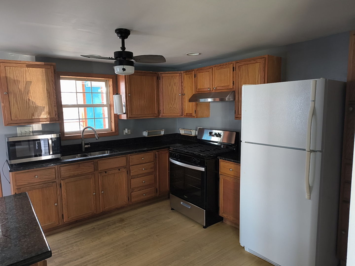 5017 West 29th Street Cicero, IL 60804 - Photo 2 of 17 a kitchen with granite countertop a refrigerator a sink a stove and cabinets