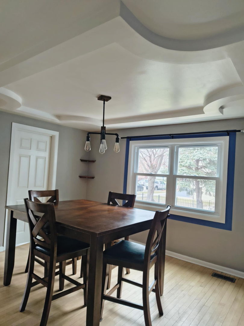 5017 West 29th Street Cicero, IL 60804 - Photo 4 of 17 a dining room with a wooden table and chairs