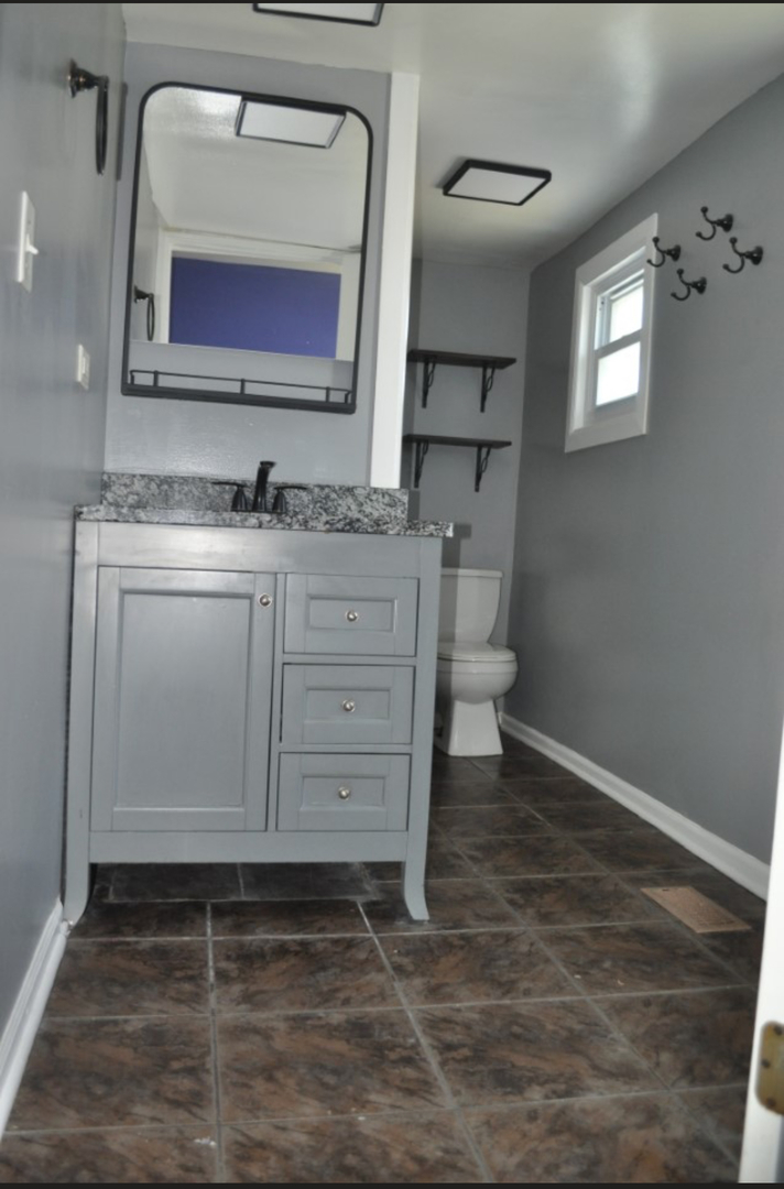 5017 West 29th Street Cicero, IL 60804 - Photo 10 of 17 a bathroom with a toilet sink and mirror