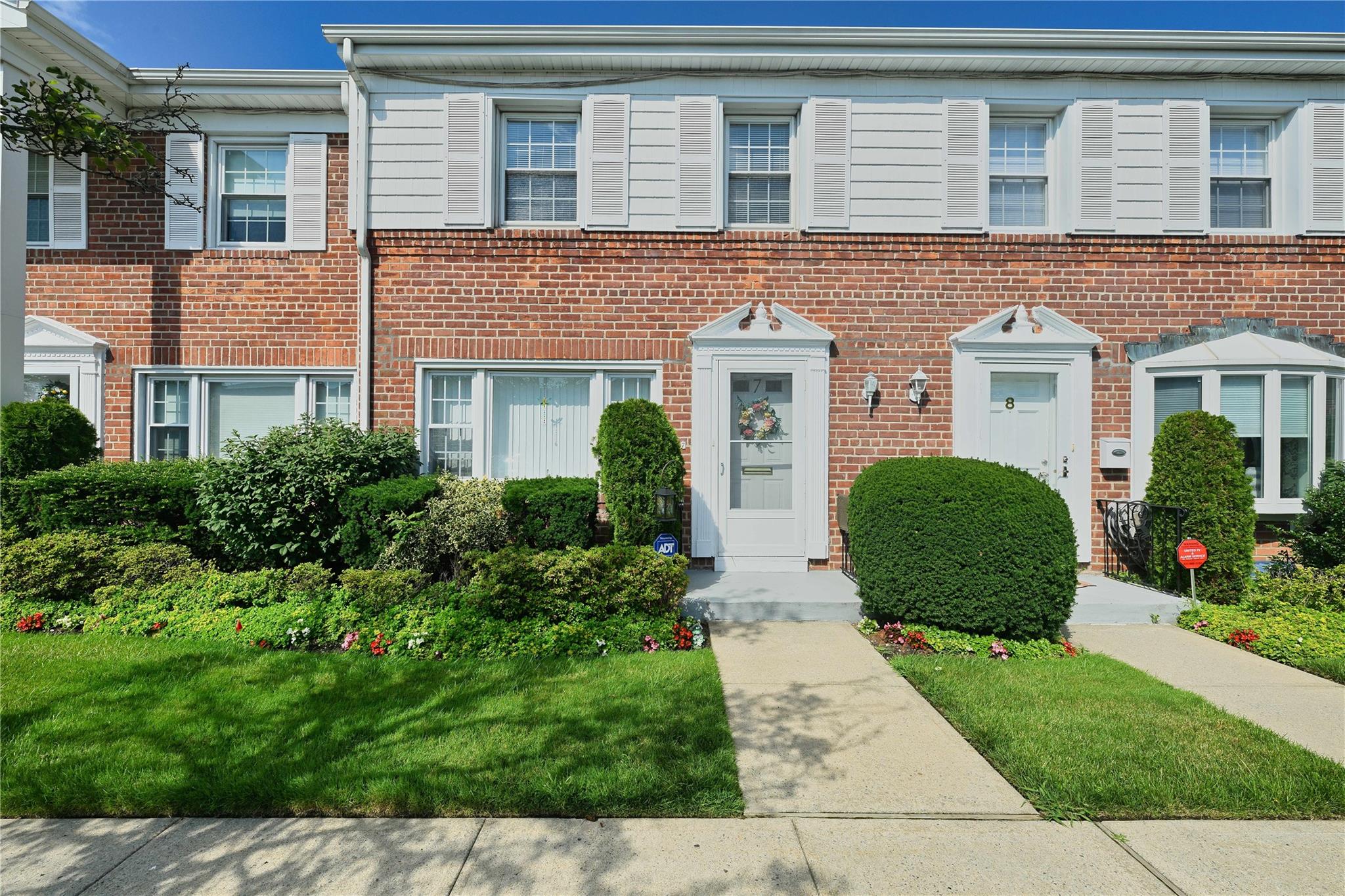 Townhome / multi-family property with brick siding