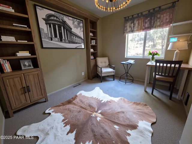 a view of a dining room with furniture and a book shelf