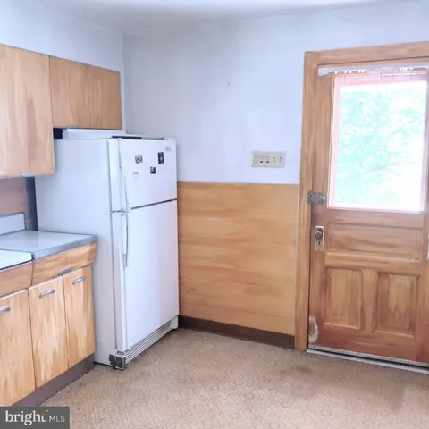 a white refrigerator freezer sitting in a kitchen