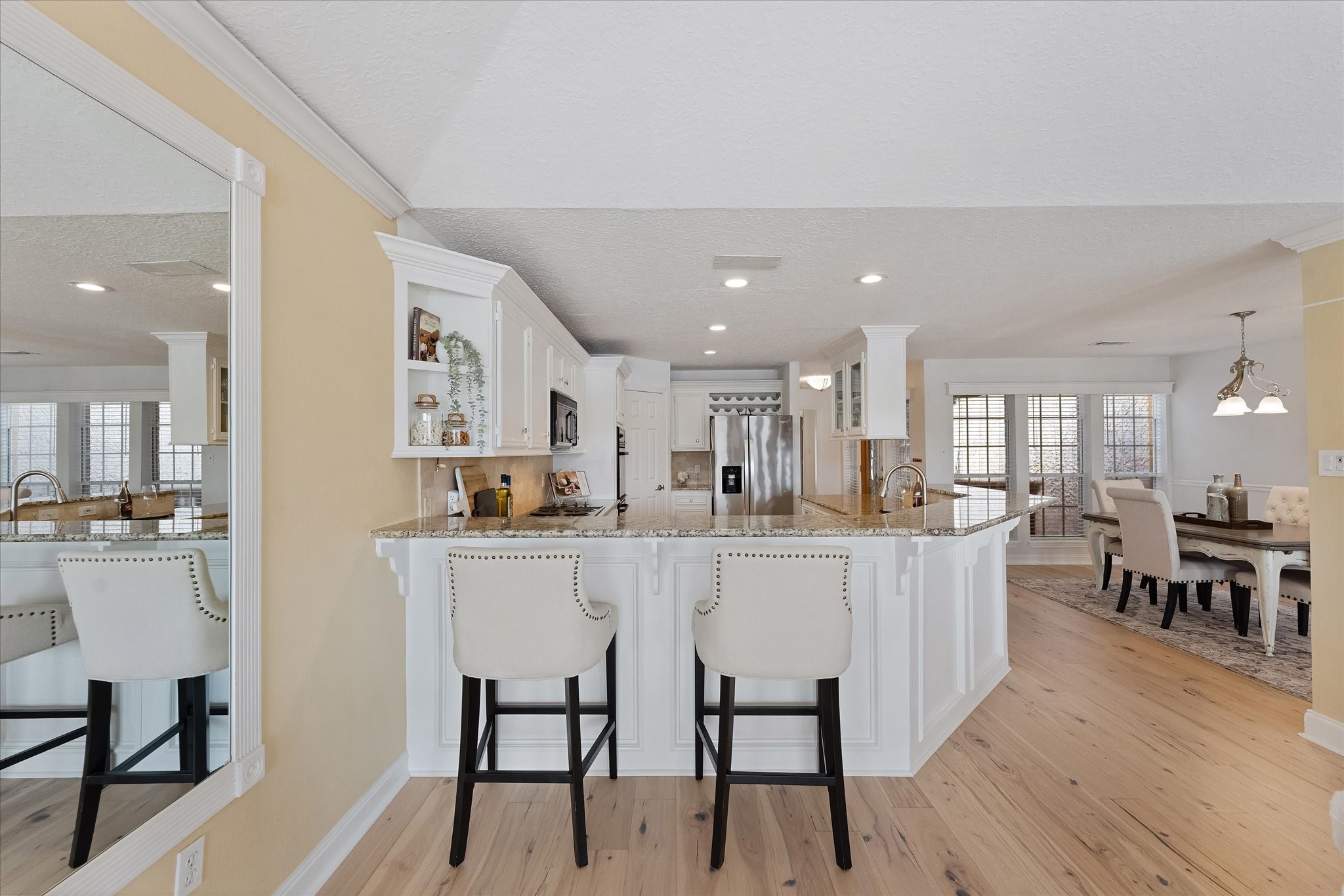 225 Capetown Conroe, TX 77356 - Photo 13 of 38 a large white dining hall with stainless steel appliances granite countertop a dining table chairs and couches