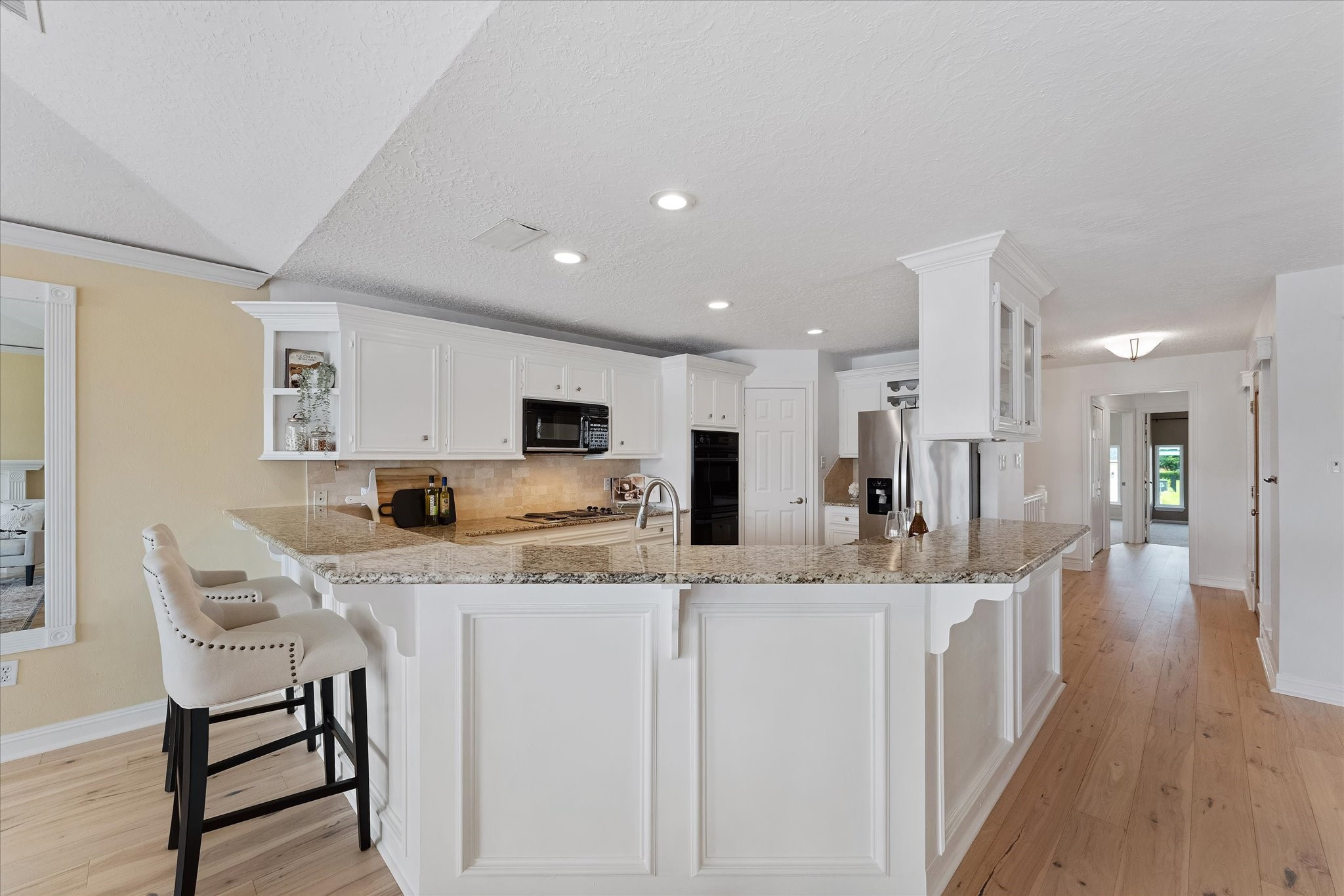225 Capetown Conroe, TX 77356 - Photo 14 of 38 a large kitchen with stainless steel appliances kitchen island granite countertop a sink and cabinets