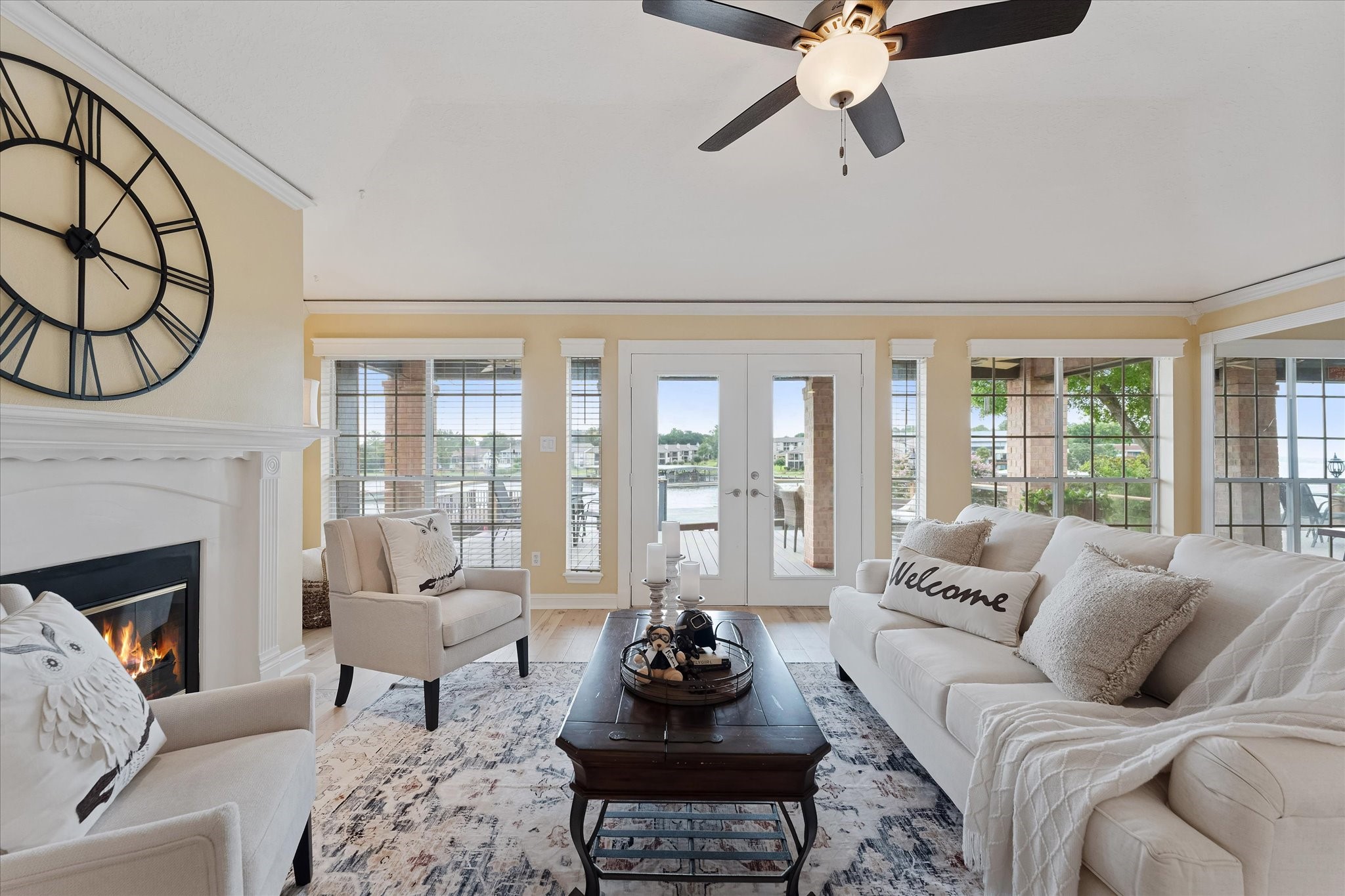 225 Capetown Conroe, TX 77356 - Photo 2 of 38 a living room with furniture a fireplace and a floor to ceiling window