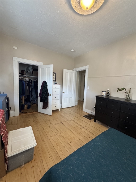 5 Spring Park Avenue, Unit 1 Boston, MA 02130 - Photo 14 of 24 a bed room with a bed and a mirror