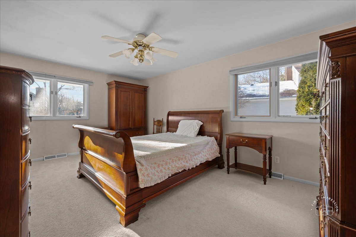 36 Winthrop New Road Sugar Grove, IL 60554 - Photo 15 of 32 a bedroom with a bed and a chandelier