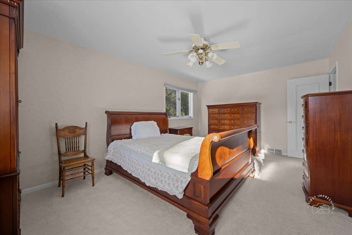 36 Winthrop New Road Sugar Grove, IL 60554 - Photo 16 of 32 a bedroom with a bed and a chandelier