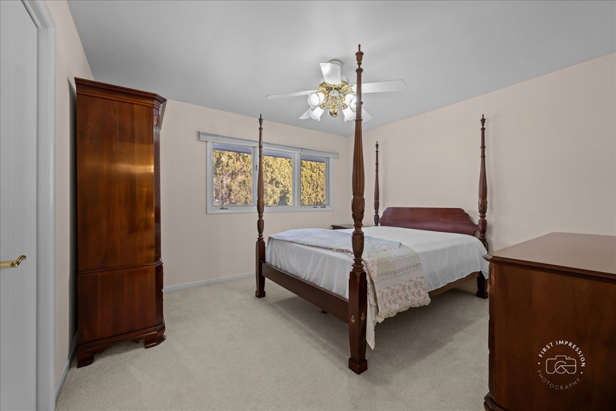 36 Winthrop New Road Sugar Grove, IL 60554 - Photo 21 of 32 a bedroom with a bed mirror and window