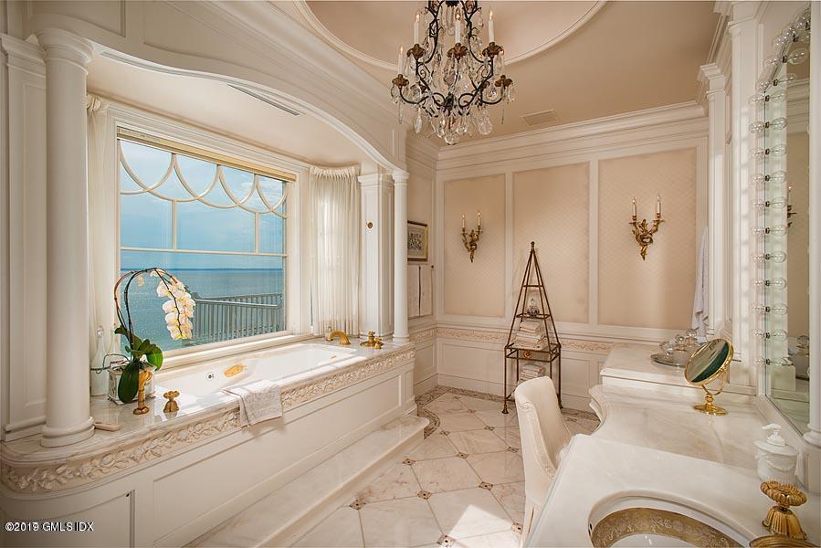 75 Byram Shore Road Greenwich, CT 06830 - Photo 16 of 33 a spacious bathroom with a granite countertop tub sink and mirror