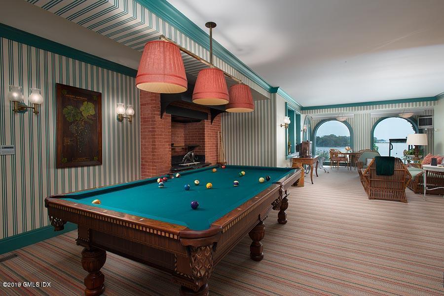 75 Byram Shore Road Greenwich, CT 06830 - Photo 31 of 33 a room with furniture pool table wooden floor and windows
