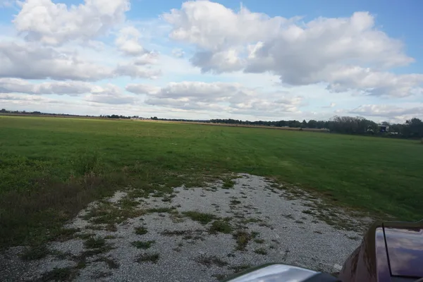 a view of a pathway with a big yard