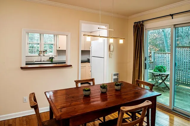 a view of a dining room with a table and chairs