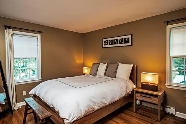 a bedroom with a bed and a window