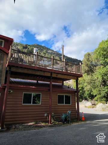97 East Main Street Stockton, UT 84071 - Photo 26 of 58 View of home's exterior with log veneer siding and a rooftop deck