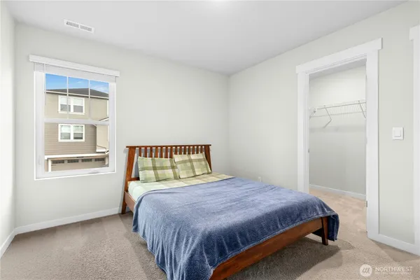 a bedroom with a bed and window