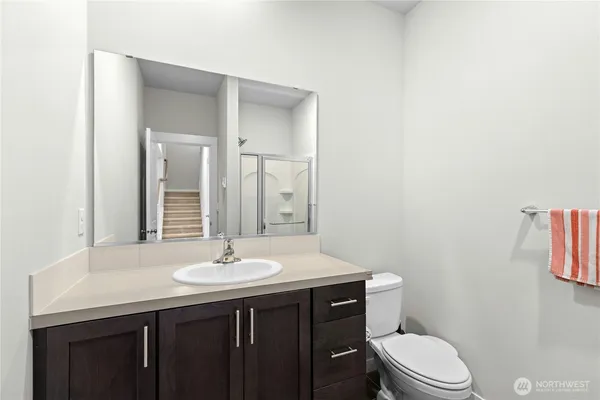 a bathroom with a sink a toilet and mirror