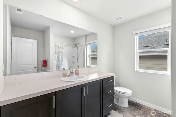 a bathroom with a sink toilet and a mirror