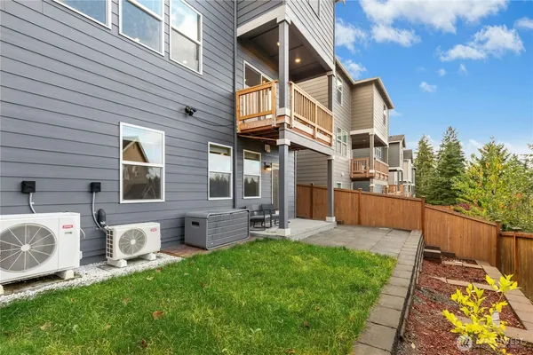 a view of a house with backyard and sitting area