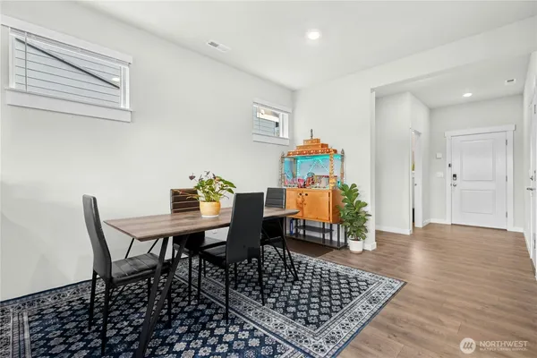 a dining room with furniture and wooden floor