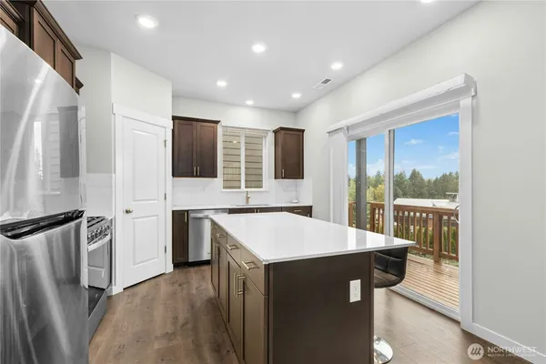 a kitchen with a refrigerator sink and stove