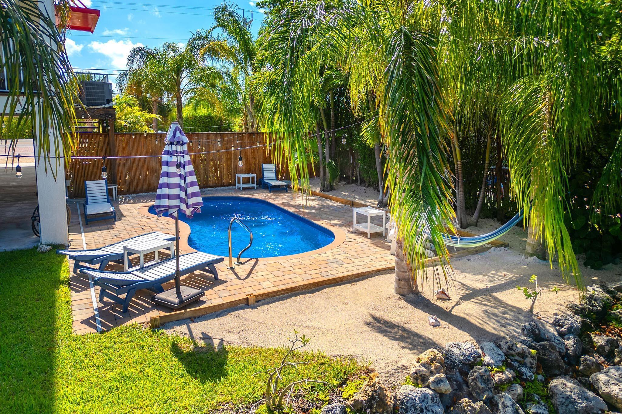 217 Sombrero Beach Road, Unit 1 & 2 Marathon, FL 33050 - Photo 15 of 67 a view of backyard with swimming pool and outdoor seating