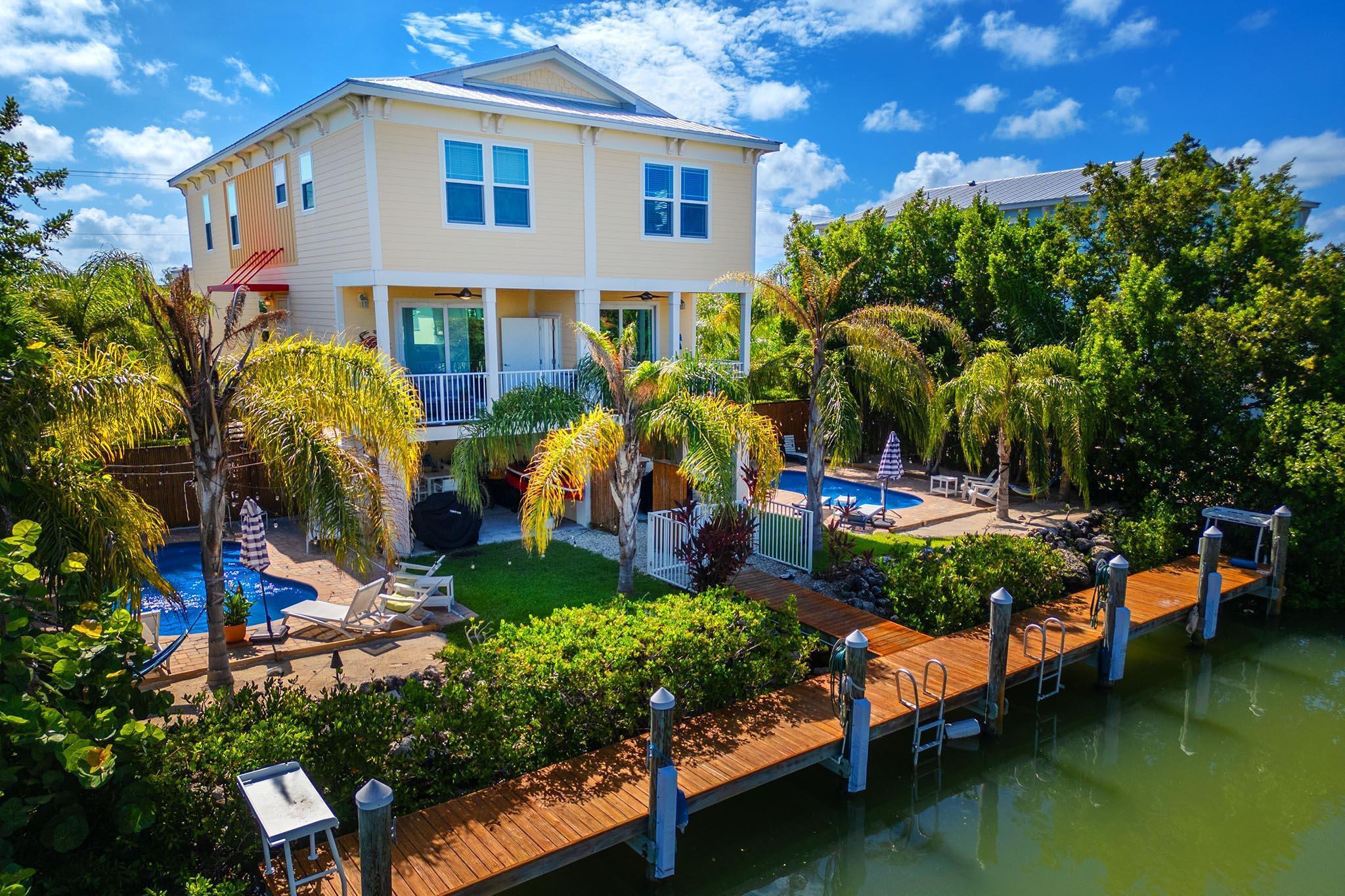 217 Sombrero Beach Road, Unit 1 & 2 Marathon, FL 33050 - Photo 17 of 67 a view of swimming pool with outdoor seating and plants