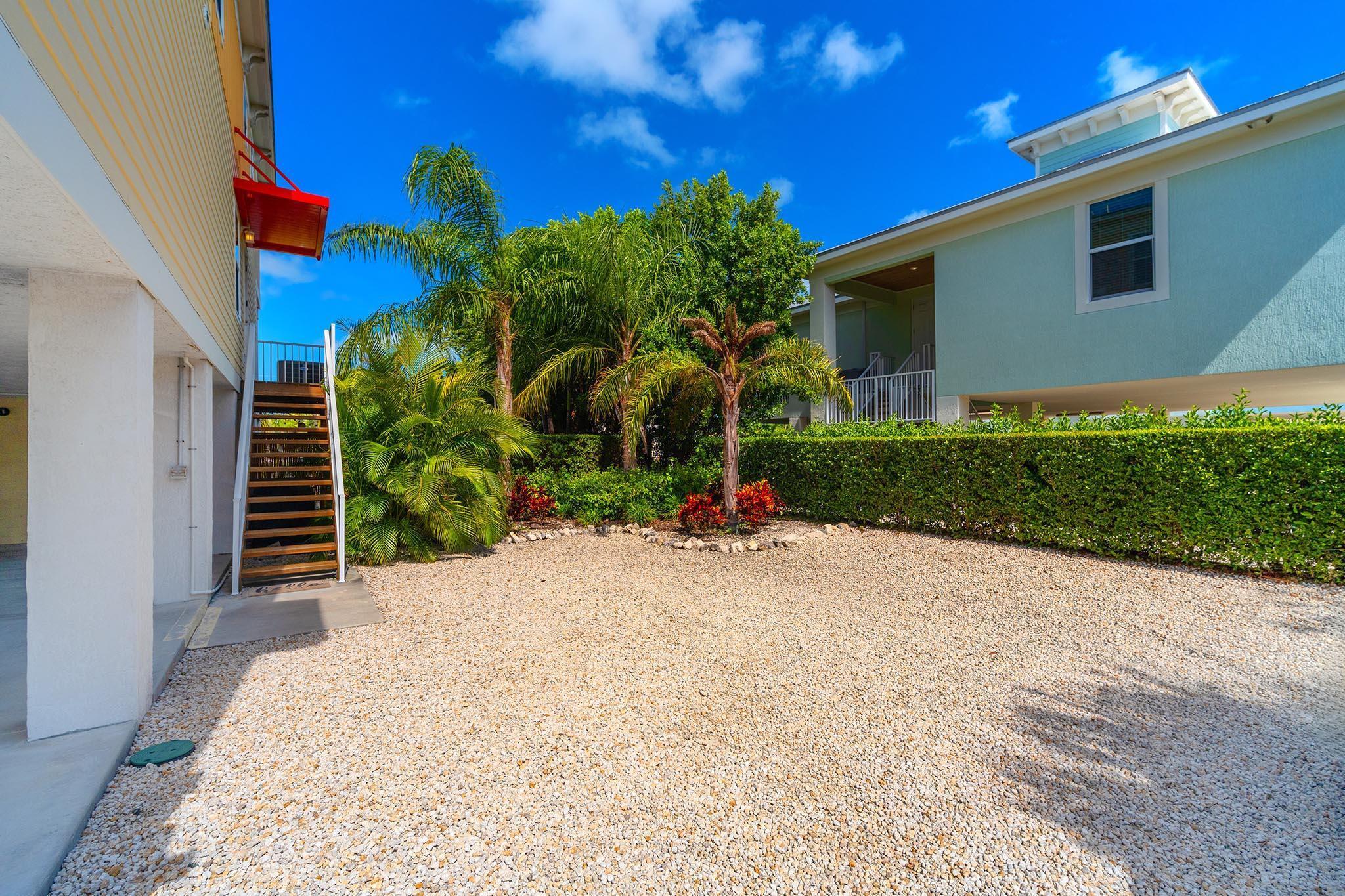 217 Sombrero Beach Road, Unit 1 & 2 Marathon, FL 33050 - Photo 25 of 67 a view of a house with a yard and potted plants