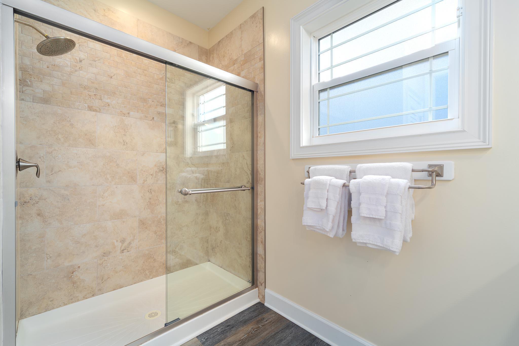 217 Sombrero Beach Road, Unit 1 & 2 Marathon, FL 33050 - Photo 49 of 67 a bathroom with a glass shower door