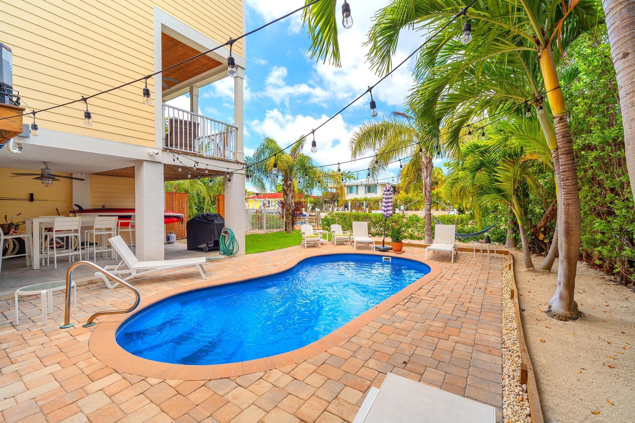 217 Sombrero Beach Road, Unit 1 & 2 Marathon, FL 33050 - Photo 57 of 67 a view of a swimming pool with lounge chairs