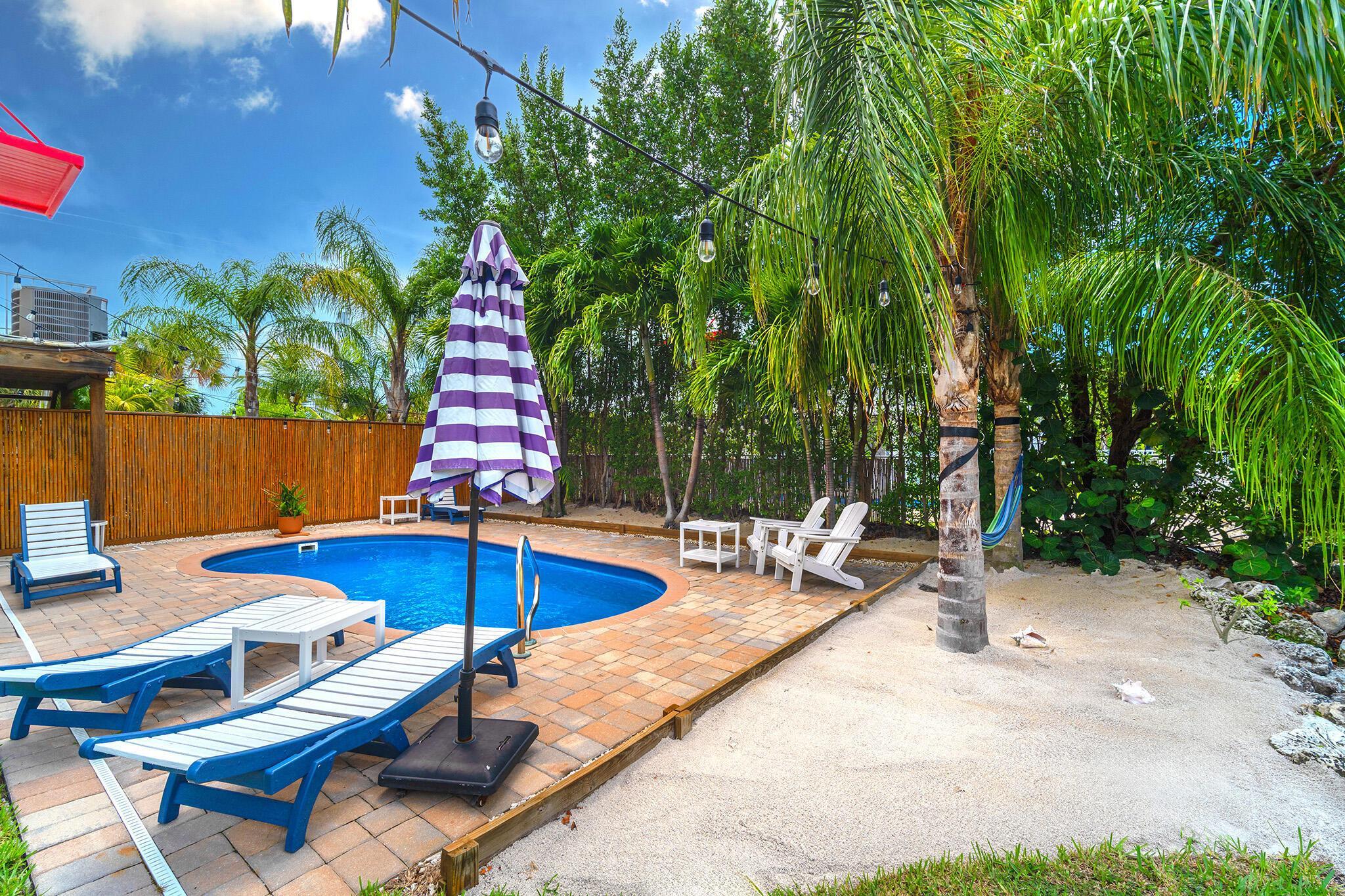 217 Sombrero Beach Road, Unit 1 & 2 Marathon, FL 33050 - Photo 59 of 67 a view of backyard with swimming pool and seating space