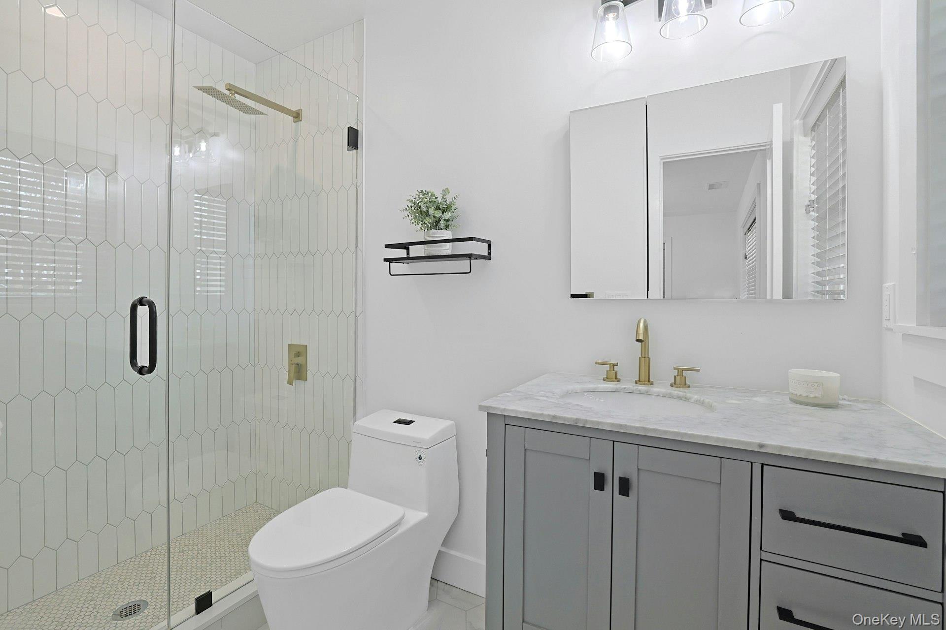 73 Bon Air Avenue New Rochelle, NY 10804 - Photo 12 of 23 a bathroom with a toilet sink vanity granite and shower