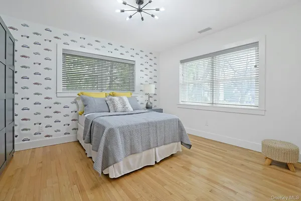 a spacious bedroom with a bed and a window