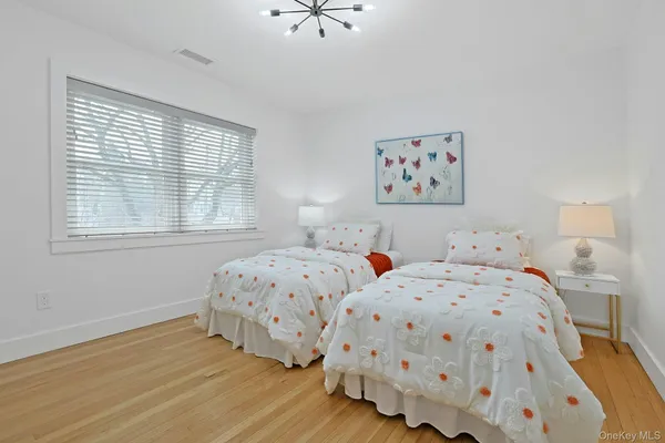 a bedroom with two beds and a window