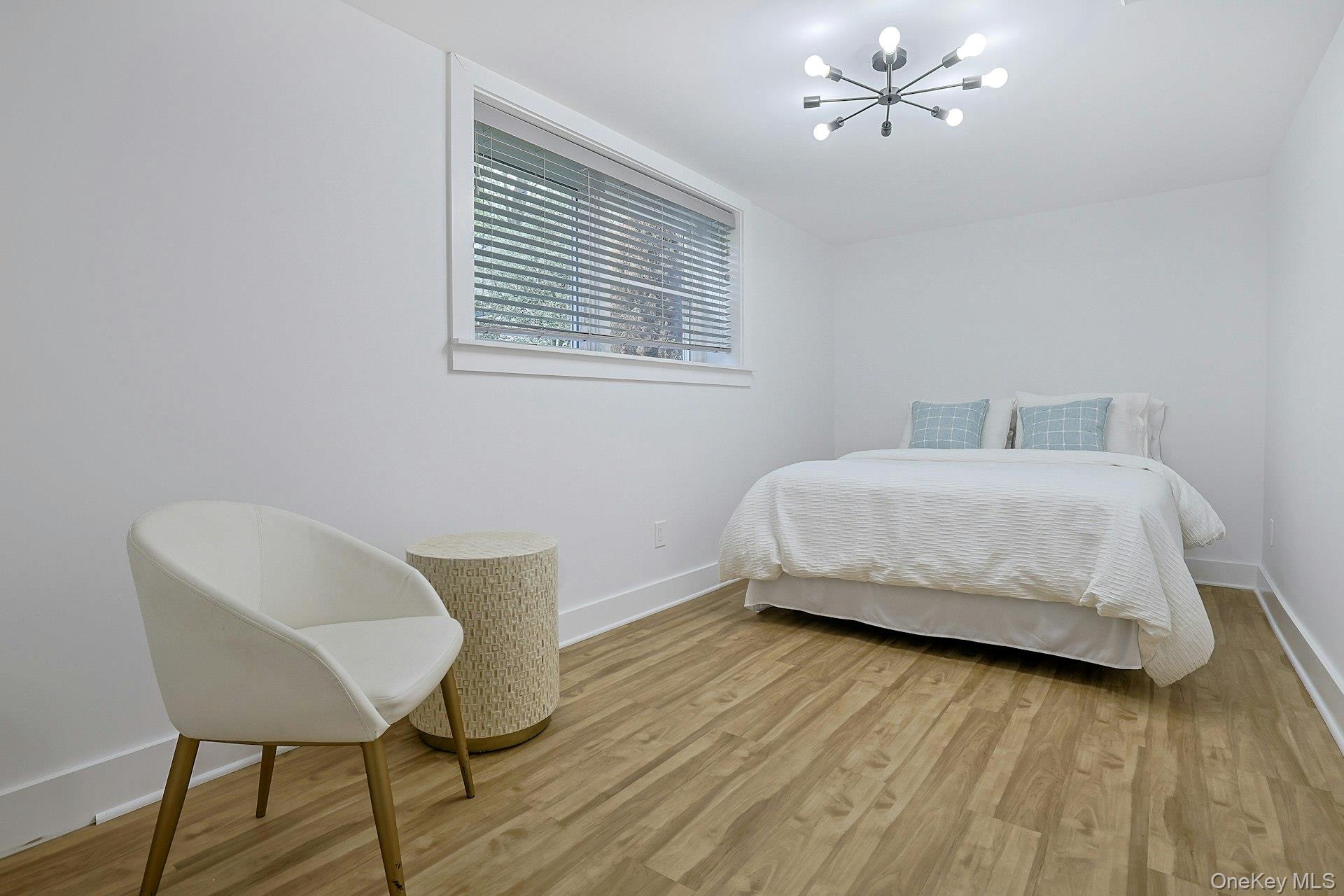 73 Bon Air Avenue New Rochelle, NY 10804 - Photo 16 of 23 a bedroom with a bed and a chair