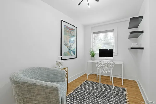 a view of a room with wooden floor and entryway