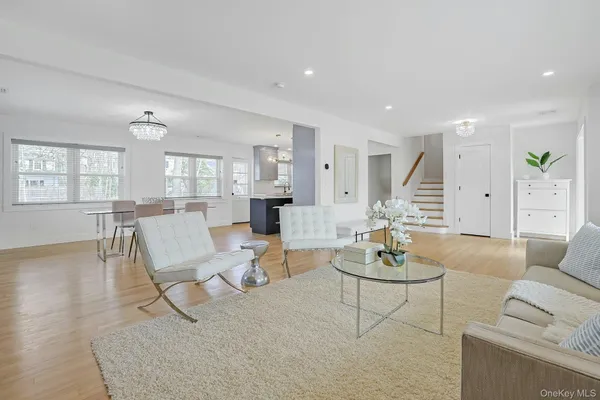 a living room with furniture or couches and a dining table with wooden floor