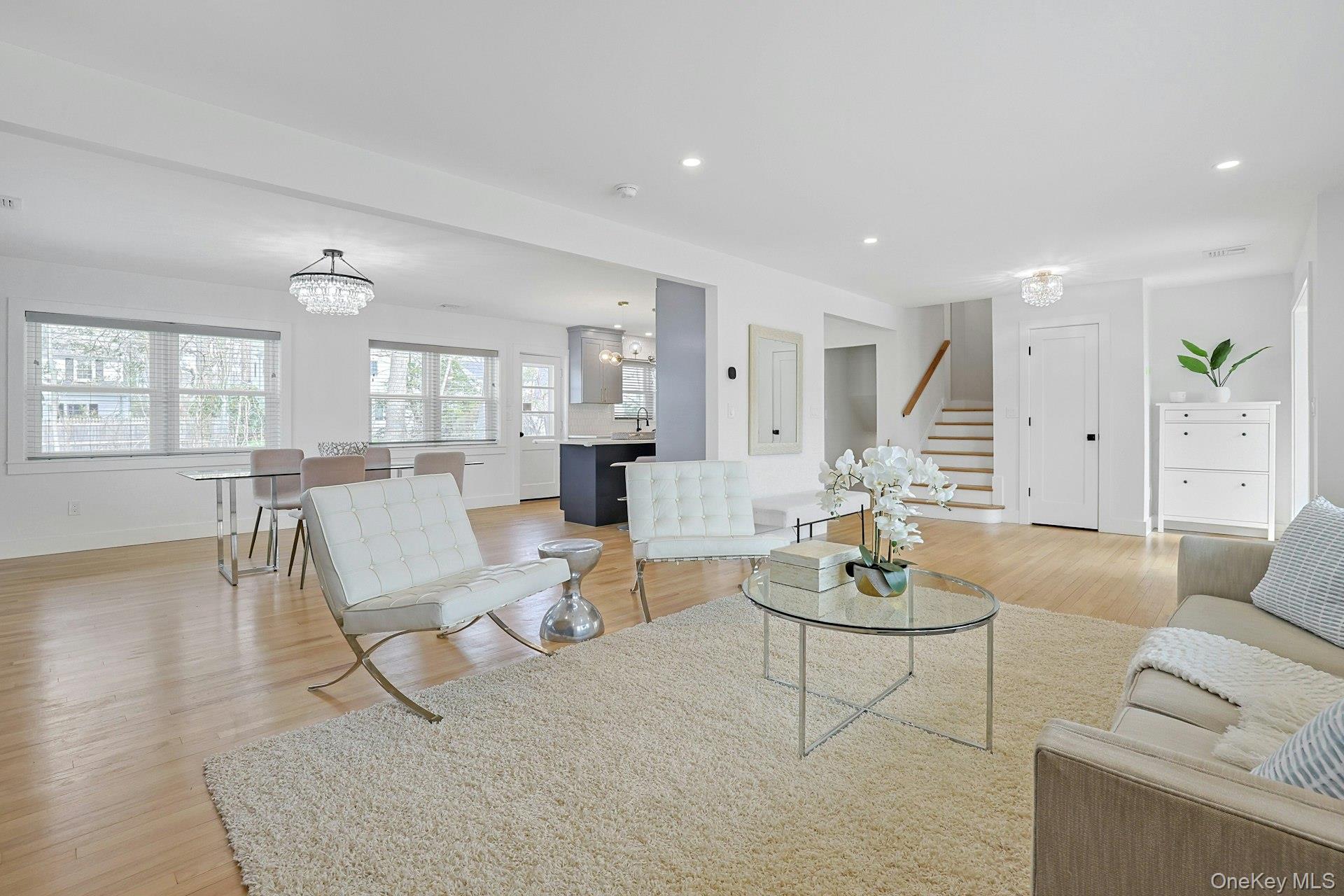 73 Bon Air Avenue New Rochelle, NY 10804 - Photo 4 of 23 a living room with furniture or couches and a dining table with wooden floor