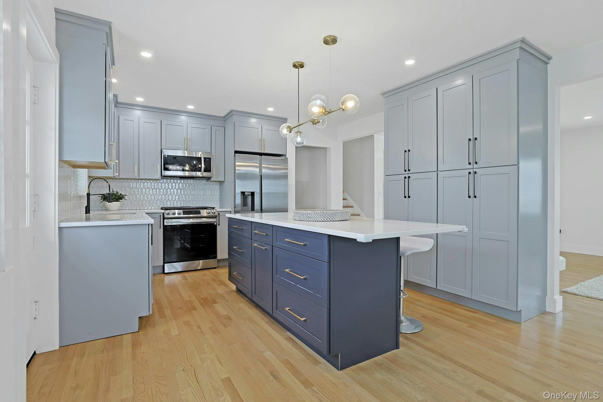 73 Bon Air Avenue New Rochelle, NY 10804 - Photo 7 of 23 a kitchen with kitchen island granite countertop wooden cabinets and stainless steel appliances