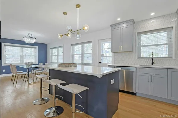 a kitchen with counter space dining table and chairs