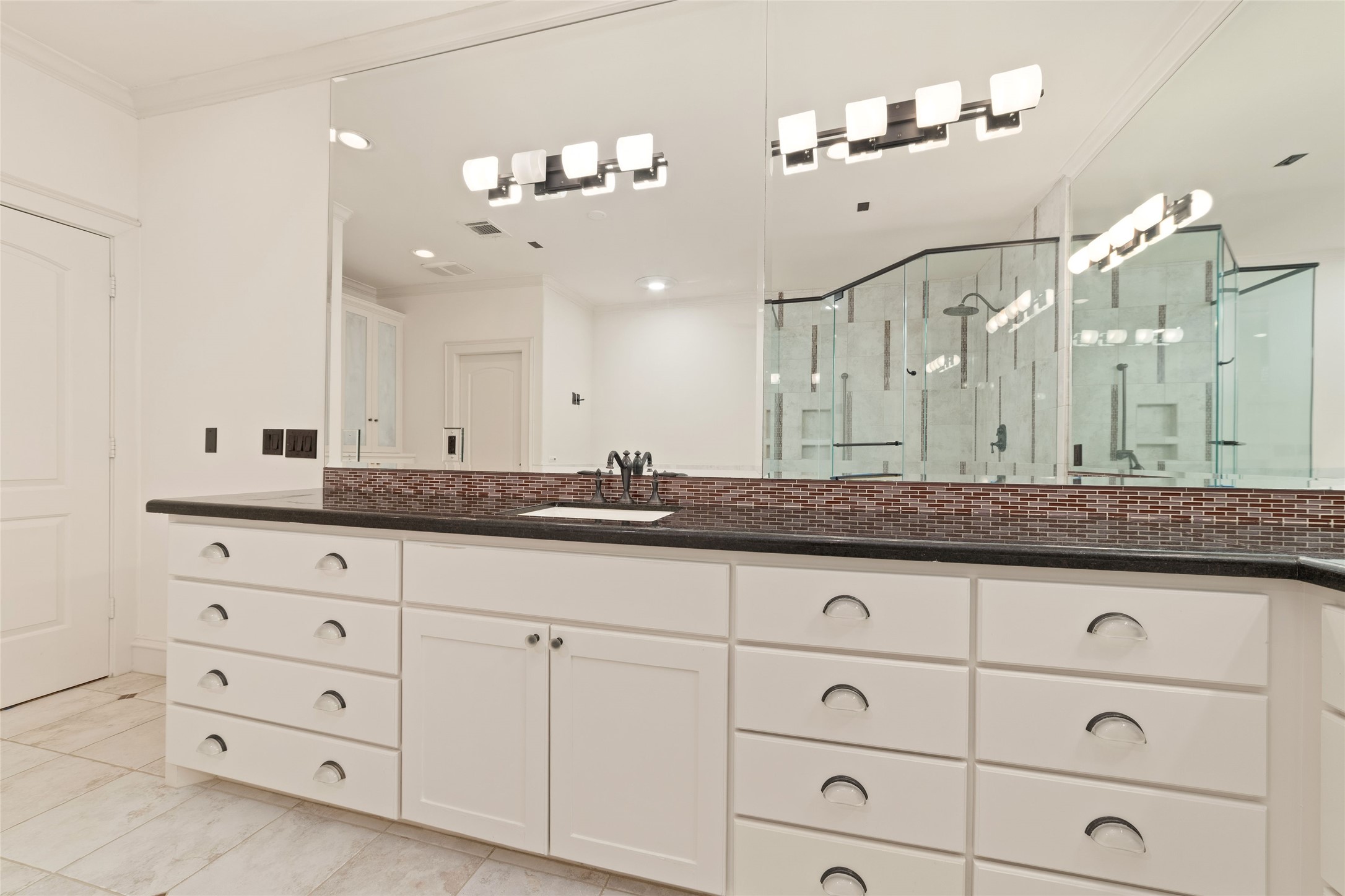 4102 Gramercy Street Houston, TX 77025 - Photo 23 of 35 a bathroom with a granite countertop double vanity sink and mirror