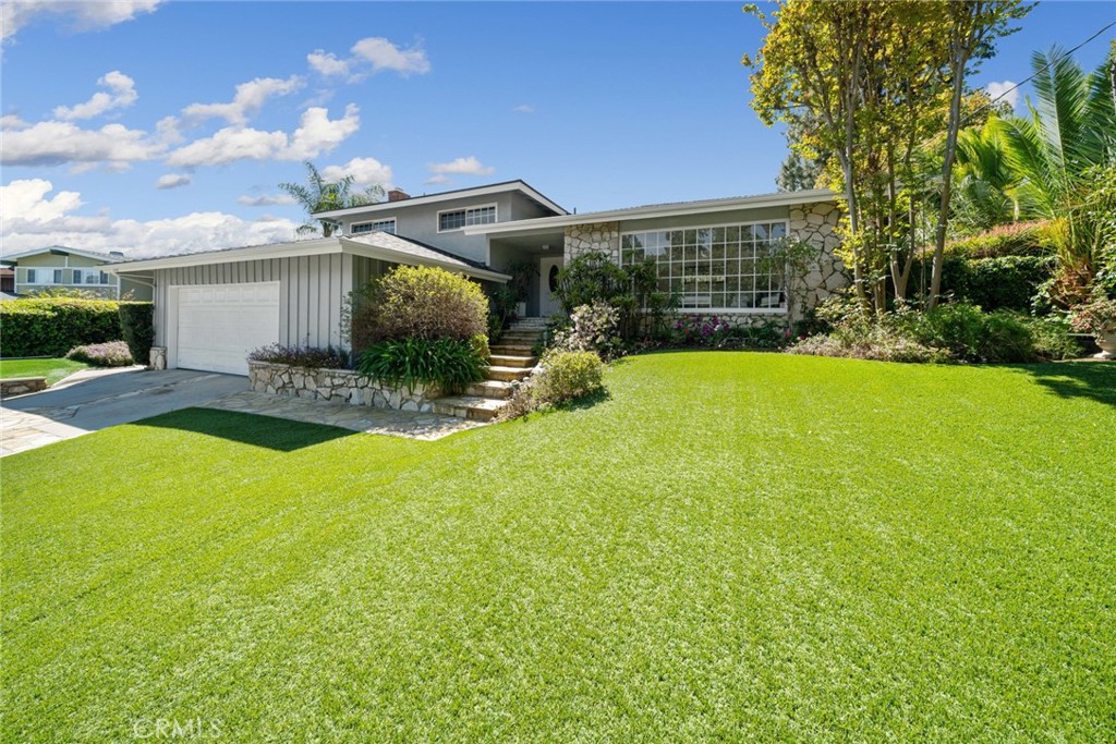 a front view of a house with garden