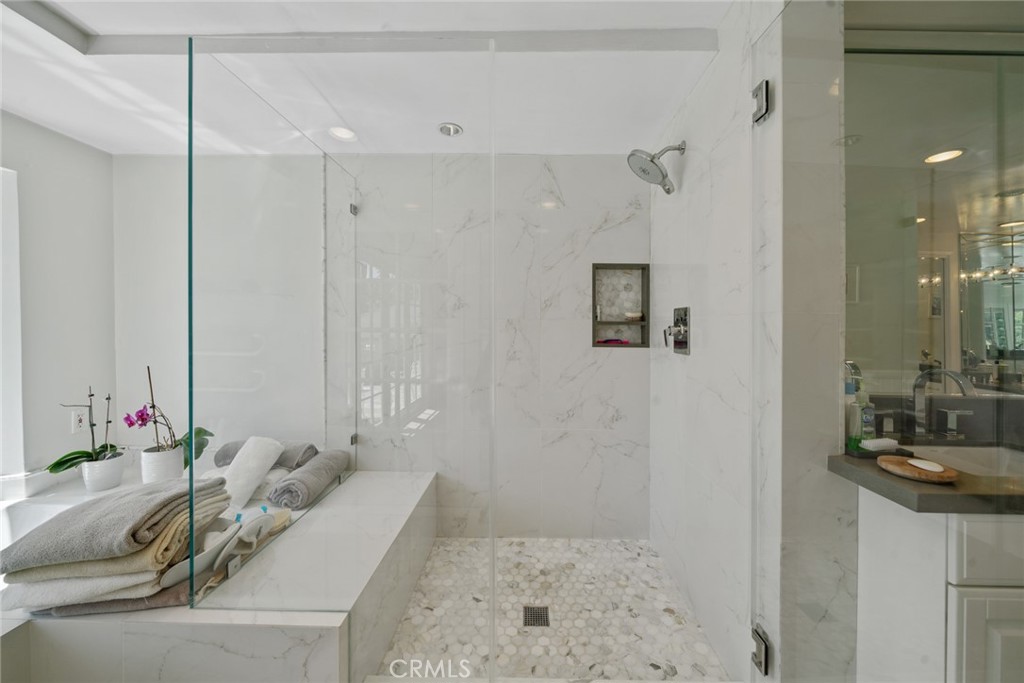 4420 Conchita Way Tarzana, CA 91356 - Photo 12 of 53 a bathroom with a granite countertop sink a mirror and a shower