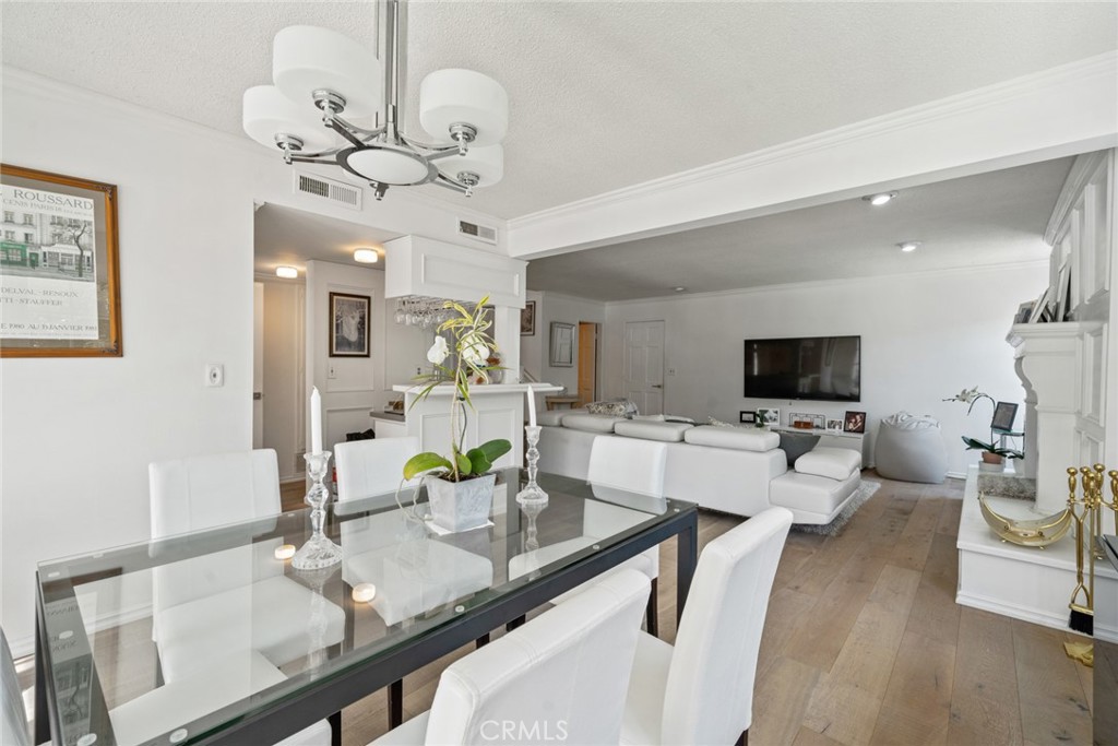 4420 Conchita Way Tarzana, CA 91356 - Photo 23 of 53 a view of a dining room with furniture a chandelier and wooden floor