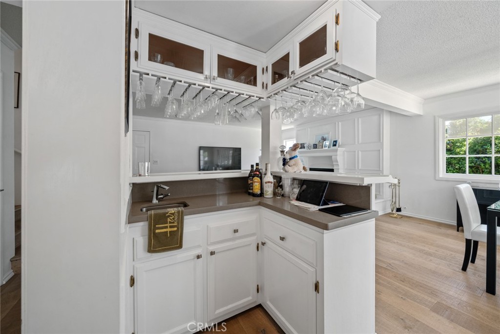 4420 Conchita Way Tarzana, CA 91356 - Photo 24 of 53 a kitchen with stainless steel appliances granite countertop a stove top oven a sink a dining table and chairs