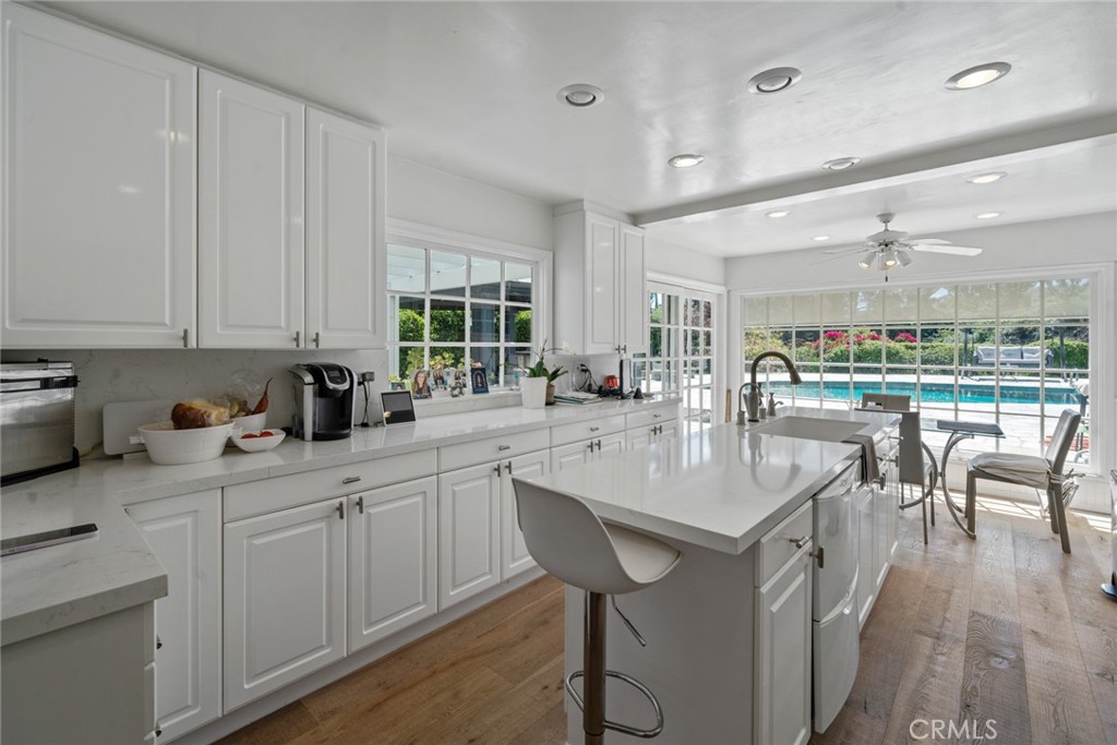 4420 Conchita Way Tarzana, CA 91356 - Photo 29 of 53 a kitchen with stainless steel appliances kitchen island granite countertop a table chairs sink and cabinets