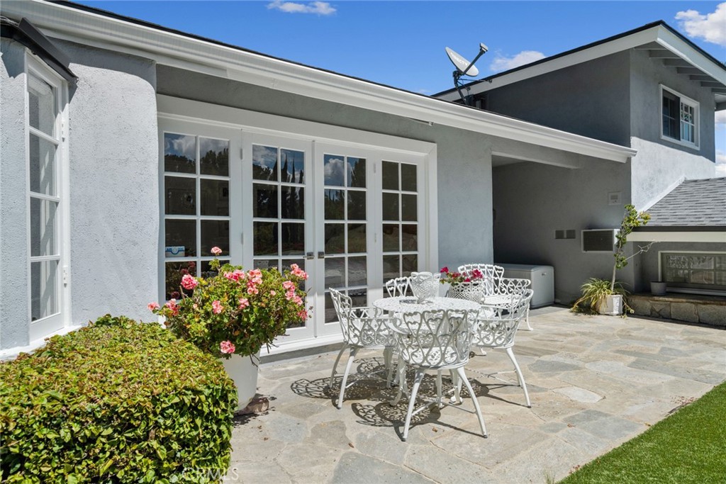 4420 Conchita Way Tarzana, CA 91356 - Photo 32 of 53 a view of a patio with table and chairs and potted plants