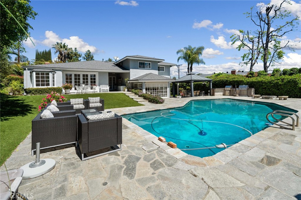 4420 Conchita Way Tarzana, CA 91356 - Photo 35 of 53 a view of a house with swimming pool and sitting area